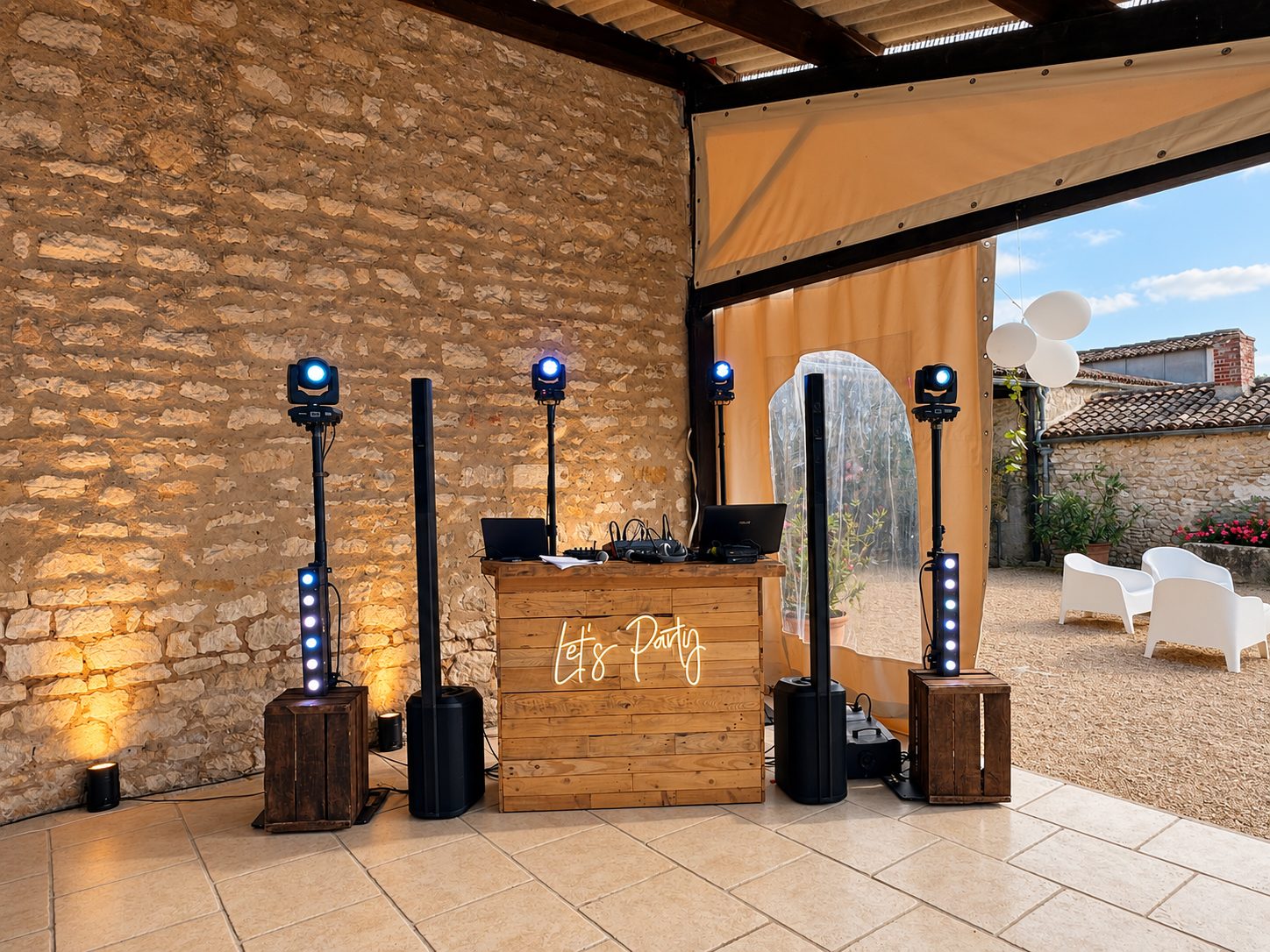 Bar DJ en bois, enceintes colonne et éclairages près d’une ouverture sur le jardin